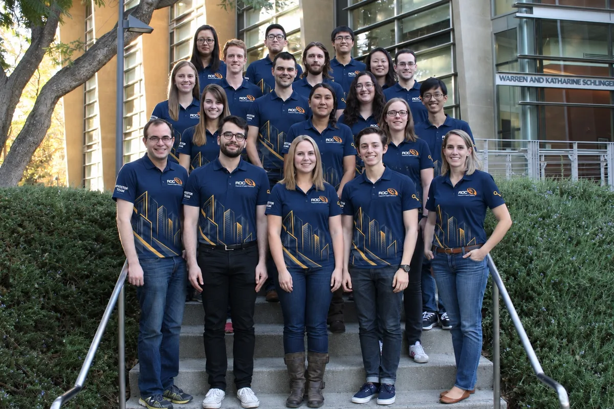 Staff in navy printed polos on a staircase
